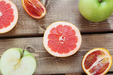Mix of fresh sliced fruits on a wooden background. Photo with depth of field.
