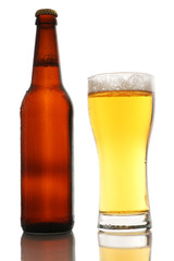 Bottle and a glass of beer with foam isolated on white background