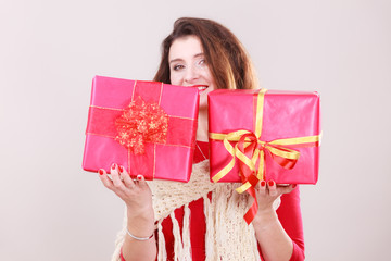Woman holds red christmas gift boxes