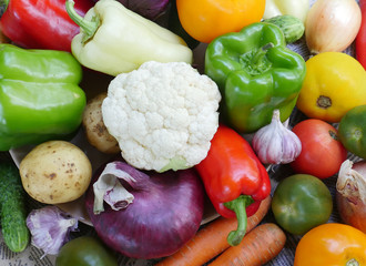 Colorful spring vegetables composition. Green onions, carrots, potatoes, cucumbers and other vegetables of spring. Assortment of fresh vegetables close up.	