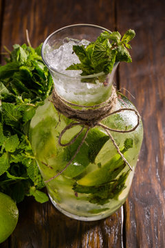 A jug with lemonade from a lime, mint and sugar syrup from soda