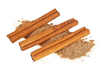 Three cinnamon sticks with powder on a white background