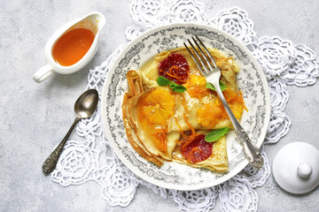 Homemade crepes suzette - traditional french thin pancakes with orange syrup.Top view.