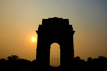 silholuette of gate of india arch in new delhi india at sunset with tourists crowd