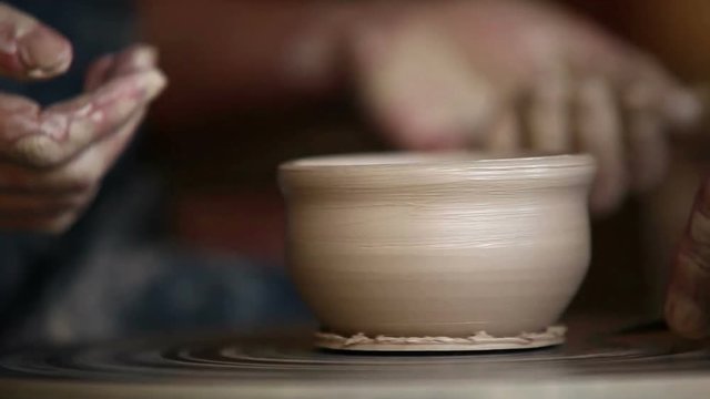 Clay cup is made by a potter traditionally on a potter's wheel