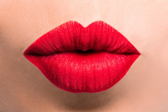 Beautiful female lips close-up. Red Lips in the form of a kiss.