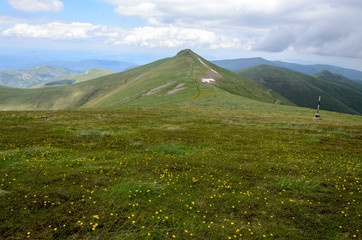 Green meadow and mountain peaks in Osogovo range, Bulgaria