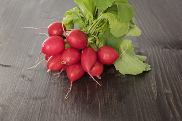 Bunch of fresh red radish on a wooden background, toned. Close up