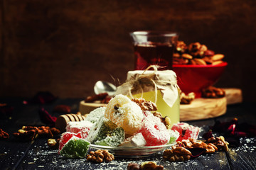 Rahat lukum, oriental sweets with honey, nuts and coconut, dark background, selective focus