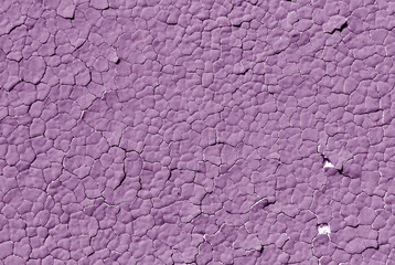 Violet color cracked plaster wall pattern.