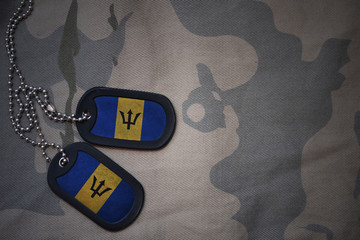 army blank, dog tag with flag of barbados on the khaki texture background. military concept