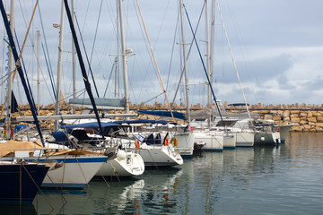 Yachts and boats in marina on a cloudy day