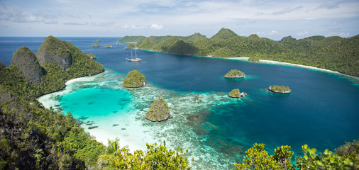 Scenic view of Wayag Islands and sailing boat Lamima Raja Ampat Indonesia