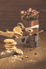 Side view of round cookies with crumbs and dry roses