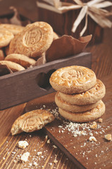 Closeup of round biscuits and crumbs on wooden plank