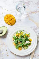 Avocado mango arugula pine nuts Mozzarella salad