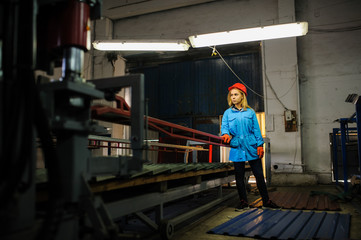 woman in red safety helmet work as industrial worker