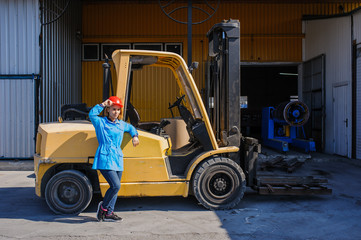 Portrait of Female Lift Truck Driver In Factory