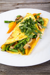 Stuffed vegetable omelet on wooden background