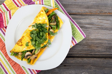 Stuffed vegetable omelet on wooden background