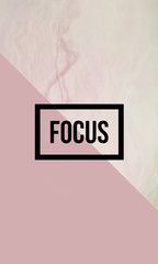 Focus motivational quote on abstract liquid background.