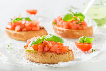 Tasty bruschetta with tomato and basil for breakfast