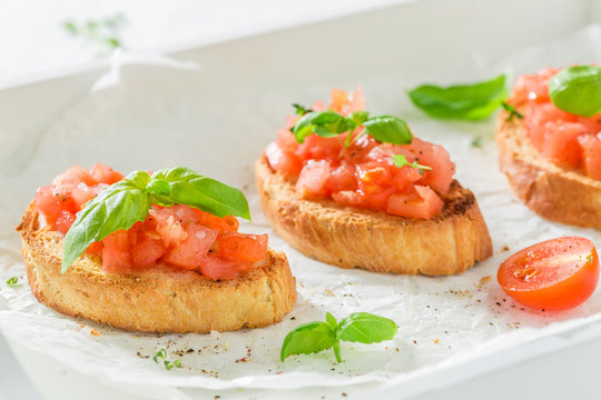 Tasty bruschetta with basil and tomato for a snack