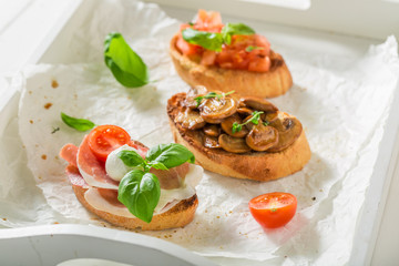 Homemade various bruschetta with fresh ingredients for breakfast