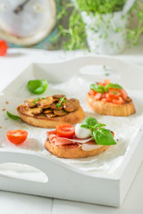 Crisp various bruschetta with fresh ingredients for breakfast