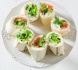 Delicious rolls with vegetables, cheese and herbs for a snack