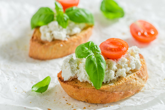 Tasty bruschetta with tomato and ricotta cheese for a snack