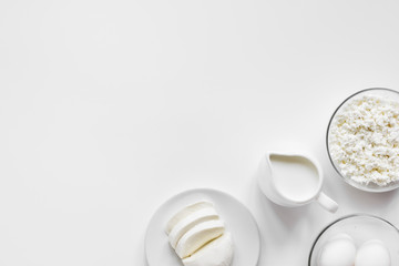 Fresh dairy products on white table background top view mockup