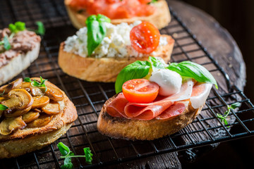 Crisp various bruschetta with fresh ingredients for a snack