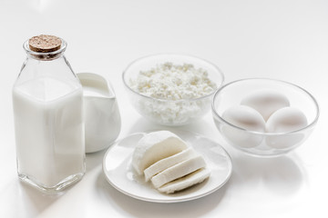 Healthy food concept with milk and cottage cheese on white table