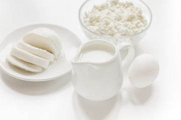 monochrome concept with dairy products on white table