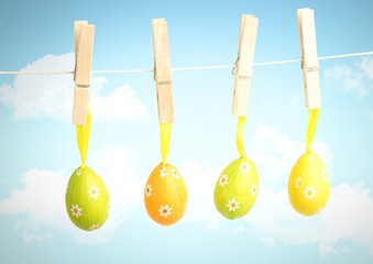 Easter Eggs on pegs in front of blue sky