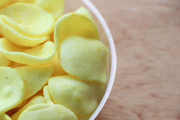 Cornflakes in plastic box on table 