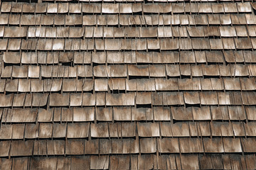 weathered wooden shingles on a roof. wooden roof tile of old house