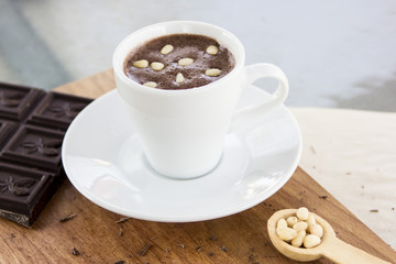 Hot chocolate with pine nuts. Sweet dessert drink in a cafe