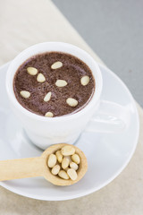 Hot chocolate with pine nuts. Sweet dessert drink in a cafe