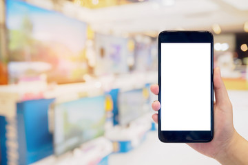 hand hold smartphone with Television shelf in eletronic department store