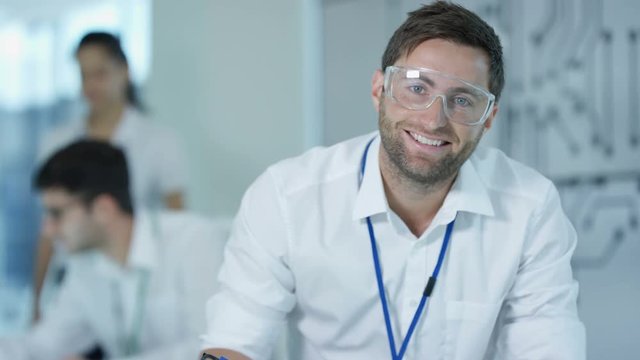  Portrait smiling electronics engineer working in the lab