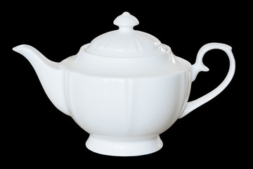 White porcelain teapot to brew tea or fragrant, healing herbs. Isolated, black background.