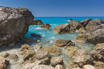 Fototapeta na wymiar Seascape with rocks in blue waters of Megali Petra Beach, Lefkada, Ionian Islands, Greece