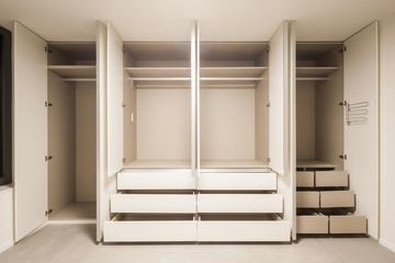 white empty room with wardrobe open for cleaning.