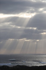 Sunlight poking through clouds on the coast of Australia