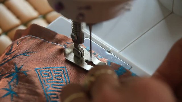 woman sewing clothes by machine
