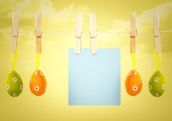 Blue note on washing line with eggs against yellow sky