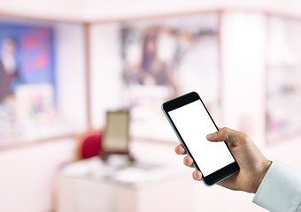 hand with phone in the store