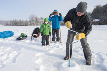 Mixed race family ice fishing
